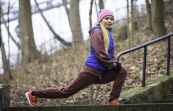 Young woman stretching before a run in the park.