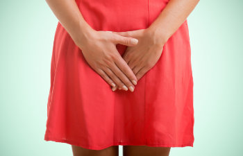 woman in red dress with groin pain